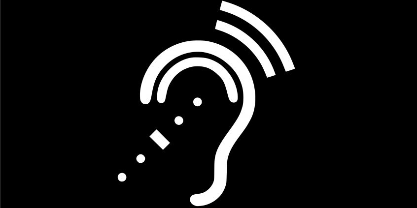 Sinal indicativo de acessibilidade para pessoa com deficiência auditiva. Fundo preto. ícone branco na forma de orelha com ondas sonoras acima