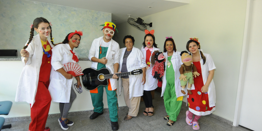 Profissionais vestindo jaleco branco e maquiagem de palhaço