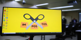 Cartaz mostra tesoura cortando a palavra "imposto"