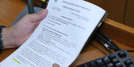 Mãos seguram pauta da reunião